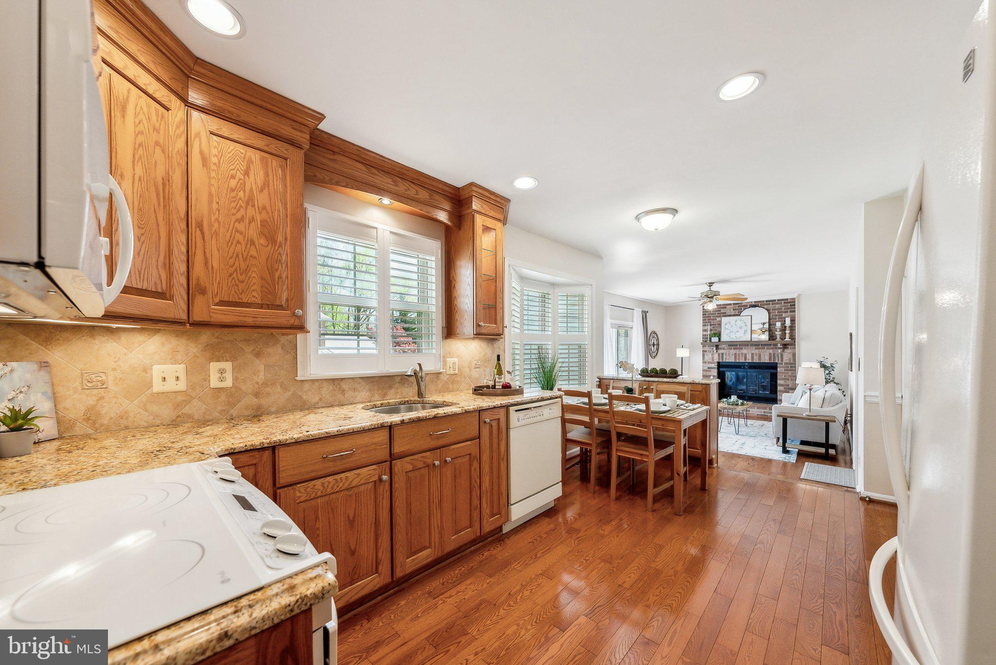 8312 Timber Brook Lane Springfield, VA 22153 - Photo 14 of 42 a kitchen with lots of counter top space and dining table