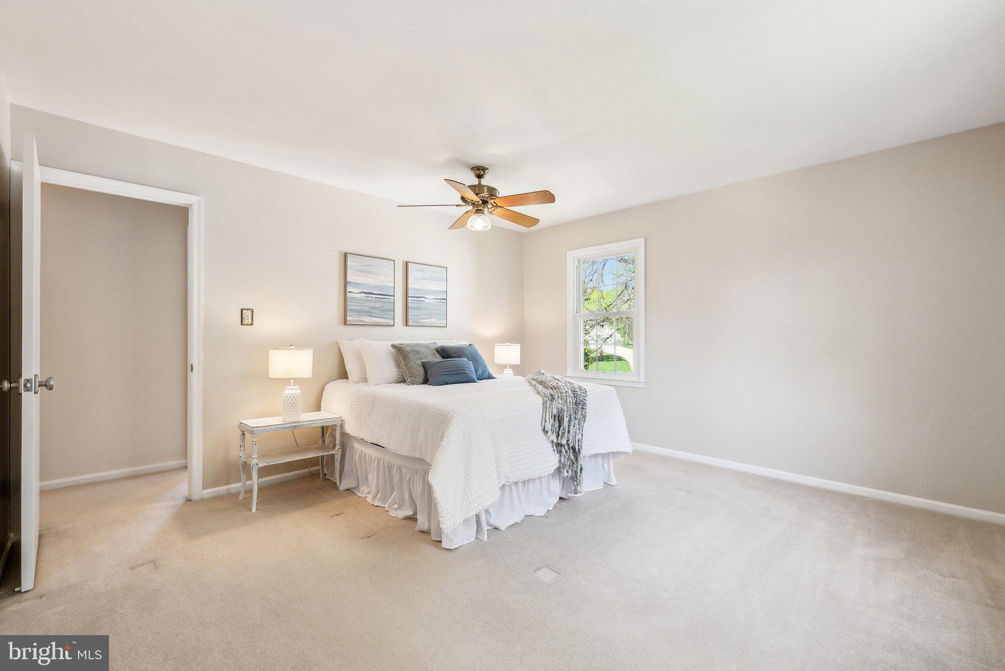 8312 Timber Brook Lane Springfield, VA 22153 - Photo 22 of 42 a spacious bedroom with a bed and a window