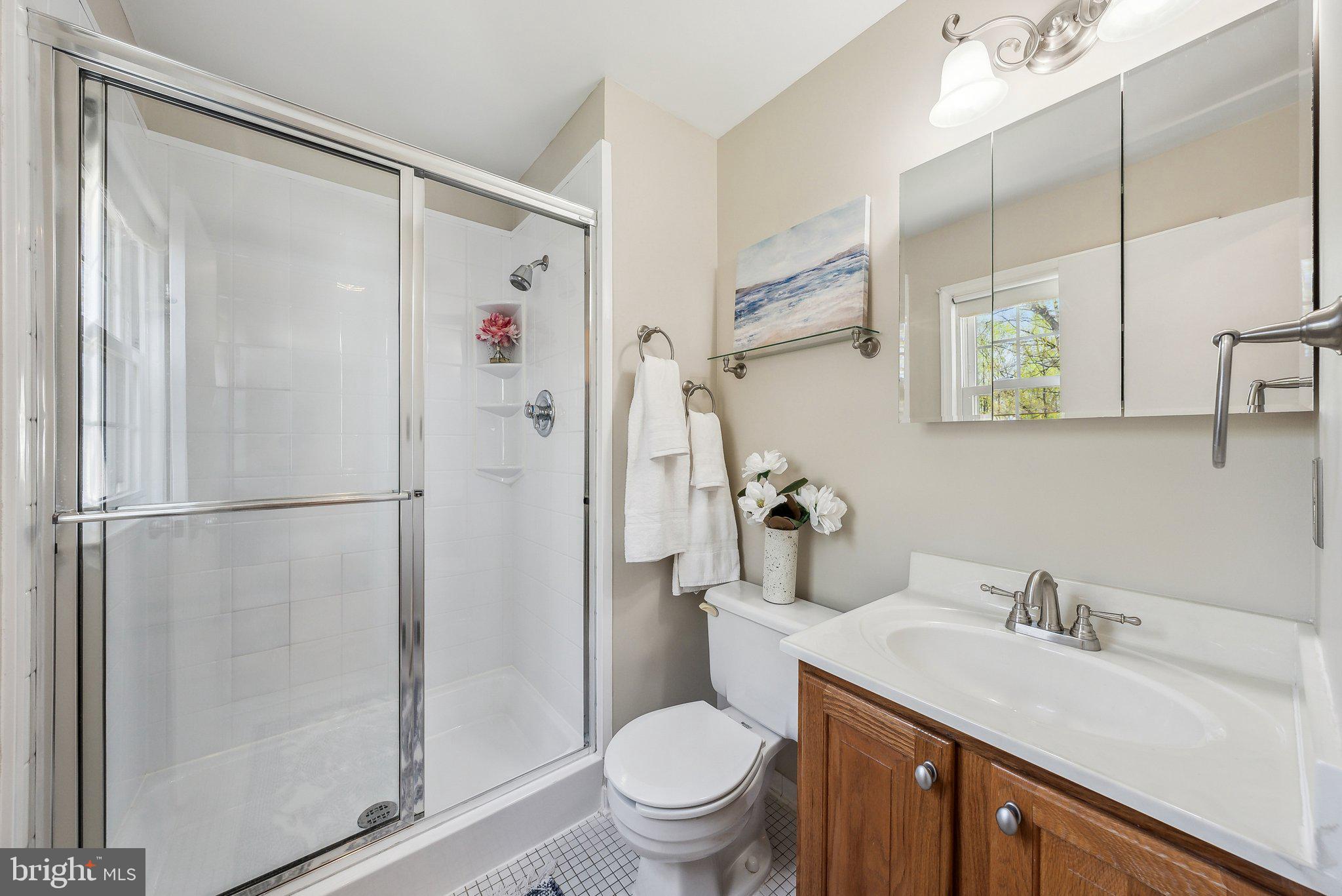 8312 Timber Brook Lane Springfield, VA 22153 - Photo 25 of 42 a bathroom with a granite countertop sink toilet and shower