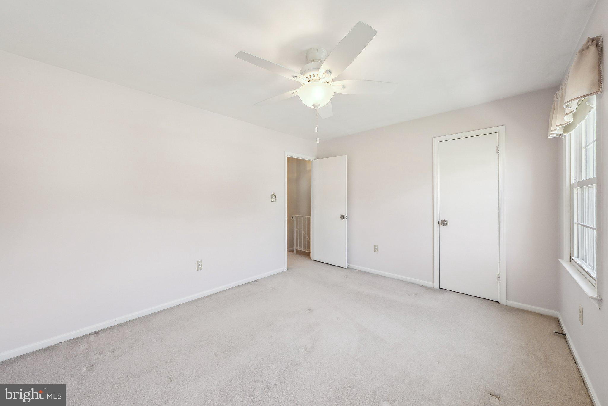 8312 Timber Brook Lane Springfield, VA 22153 - Photo 27 of 42 an empty room with windows and fan