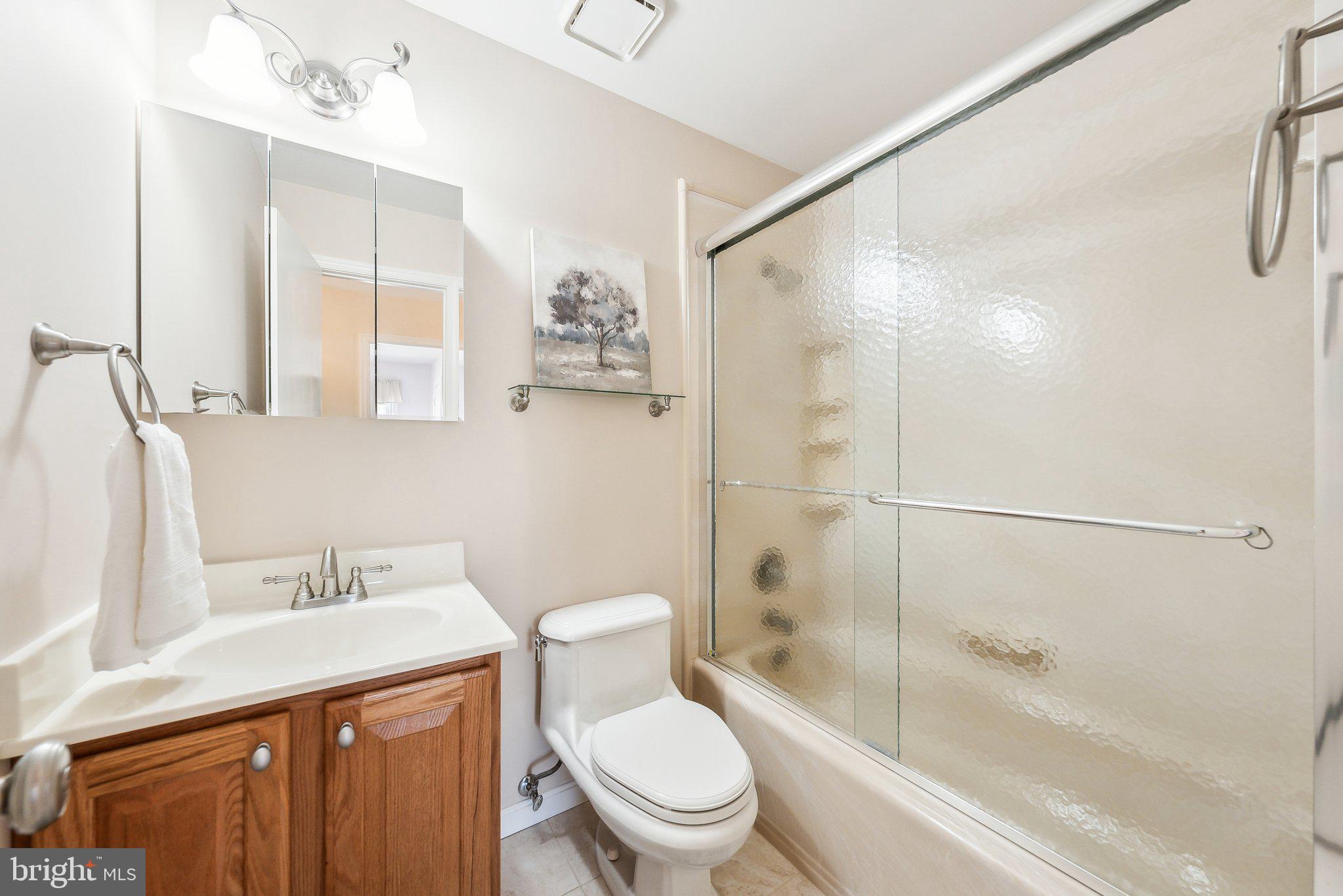 8312 Timber Brook Lane Springfield, VA 22153 - Photo 28 of 42 a bathroom with a sink a toilet and a bathtub