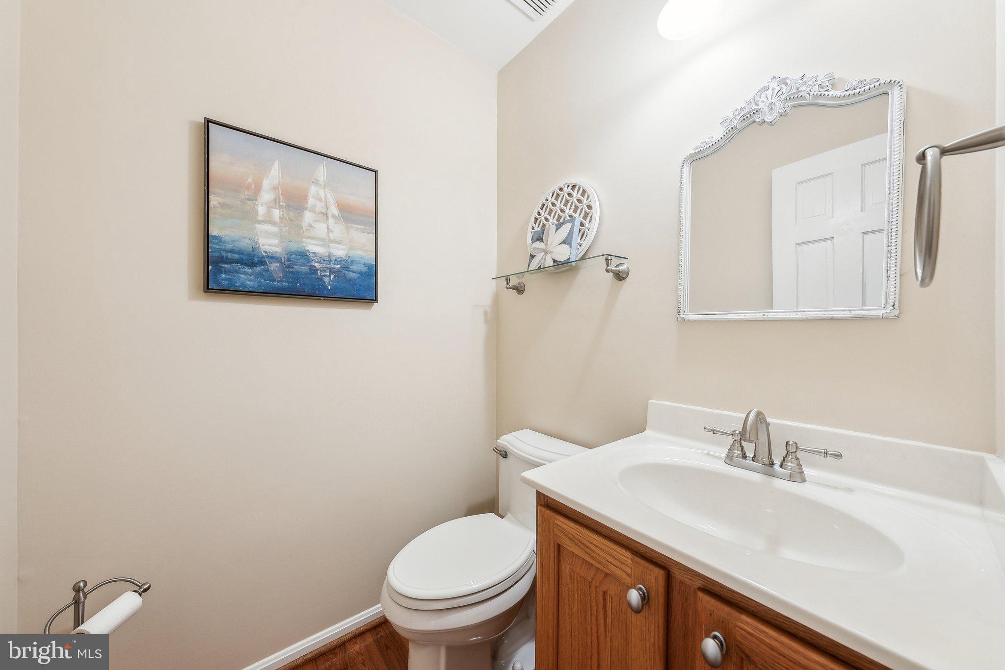 8312 Timber Brook Lane Springfield, VA 22153 - Photo 8 of 42 a bathroom with a toilet a sink and mirror
