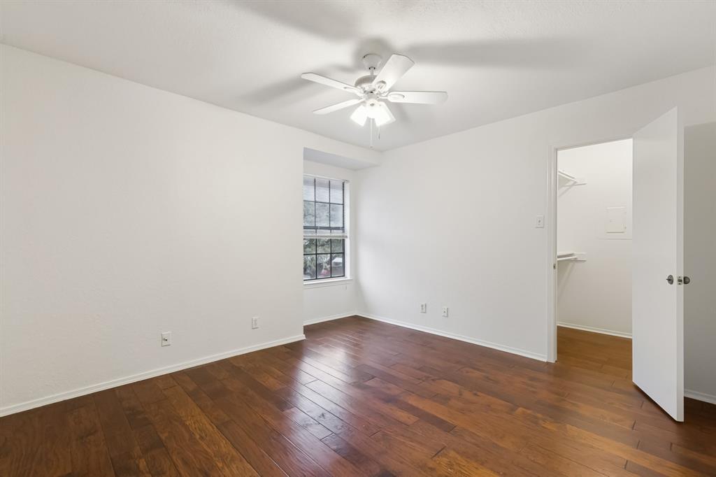 4748 Old Bent Tree Lane, Unit 1808 Dallas, TX 75287 - Photo 9 of 28 wooden floor in an empty room with a window