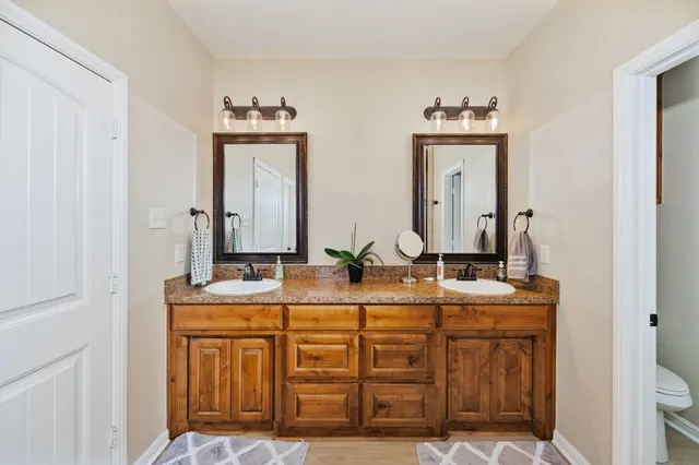 a bathroom with a double vanity sink and a mirror