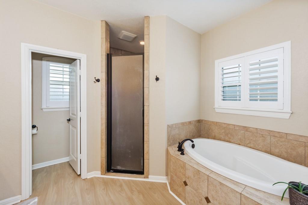 151 Conestoga Court Rhome, TX 76078 - Photo 15 of 38 a bathroom with a bathtub and a shower