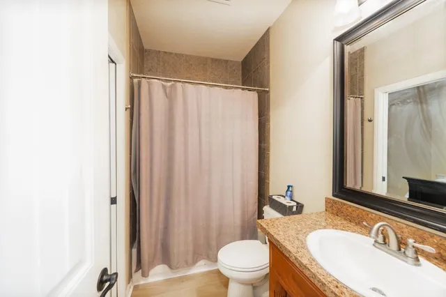 a bathroom with a sink toilet and shower