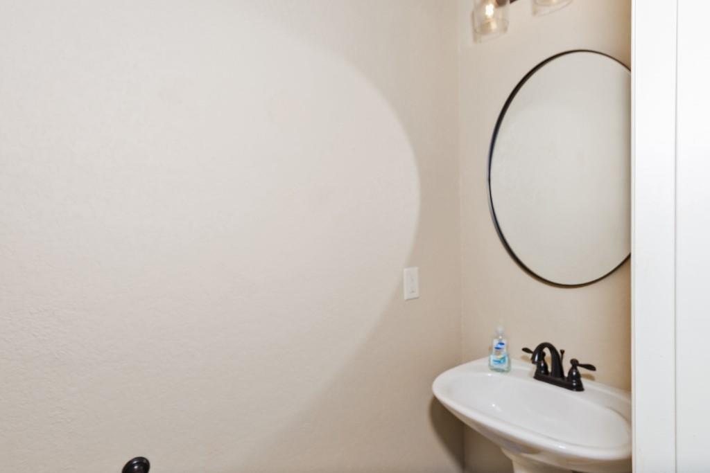 151 Conestoga Court Rhome, TX 76078 - Photo 18 of 38 a bathroom with a sink and a mirror