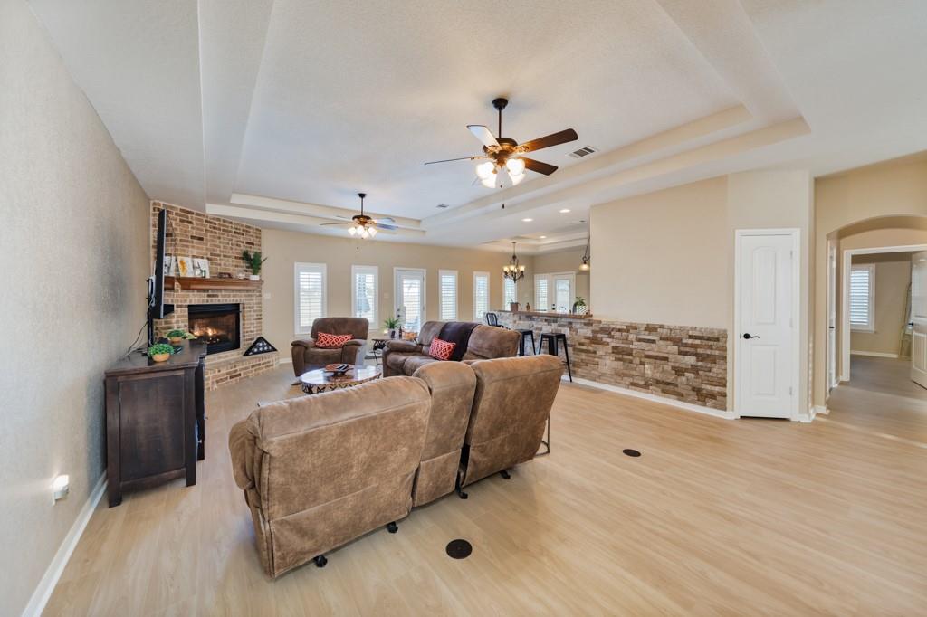 151 Conestoga Court Rhome, TX 76078 - Photo 20 of 38 a living room with furniture and a wooden floor