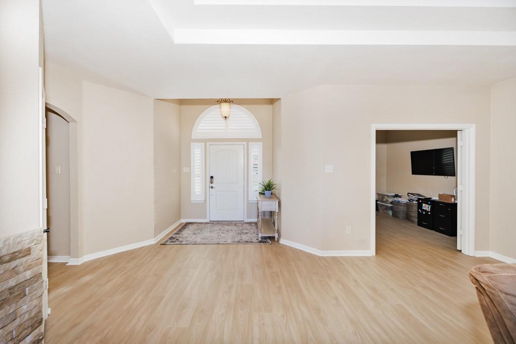 151 Conestoga Court Rhome, TX 76078 - Photo 22 of 38 a view of a livingroom with wooden floor & a sink