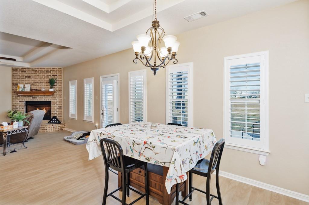 151 Conestoga Court Rhome, TX 76078 - Photo 23 of 38 a view of a dining room with furniture window and wooden floor