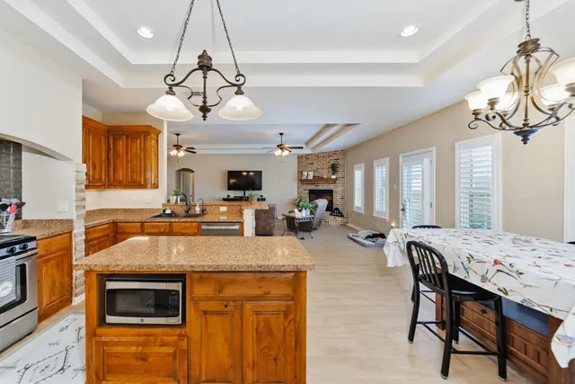 a kitchen with a stove a sink a dining table and chairs