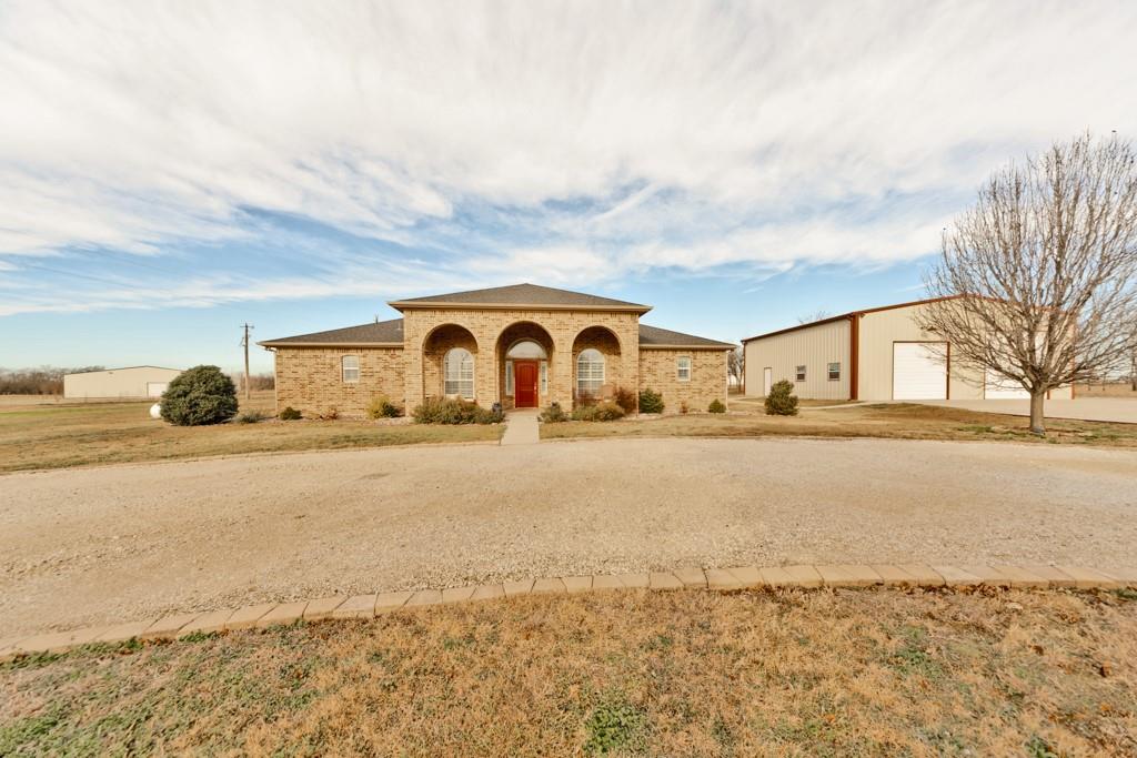 151 Conestoga Court Rhome, TX 76078 - Photo 3 of 38 a front view of house with yard and ocean