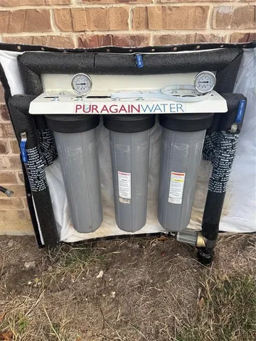 a vase of water sitting next to a yard