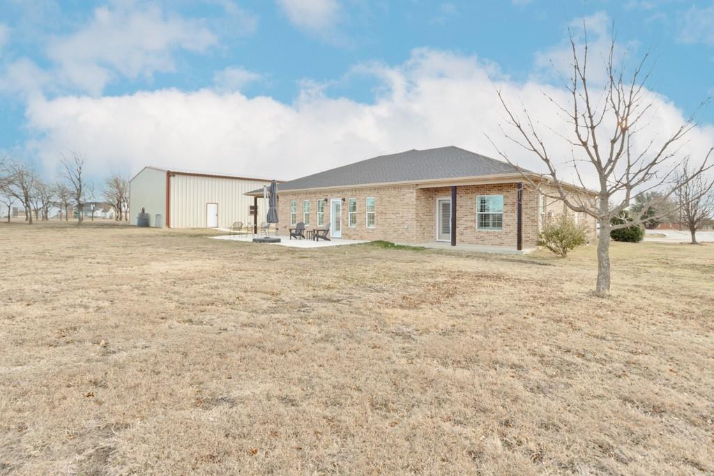 151 Conestoga Court Rhome, TX 76078 - Photo 8 of 38 a view of a house with a yard