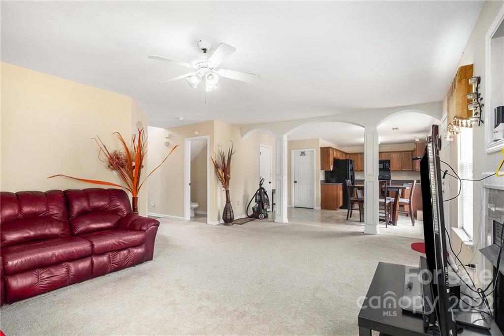 1222 Ben Livingston Road Charlotte, NC 28214 - Photo 11 of 32 a living room with furniture a ceiling fan and a rug