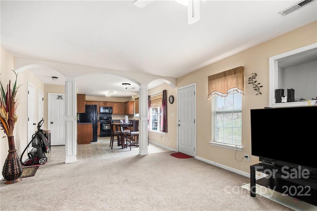 1222 Ben Livingston Road Charlotte, NC 28214 - Photo 12 of 32 a view of a livingroom with furniture and a flat screen tv