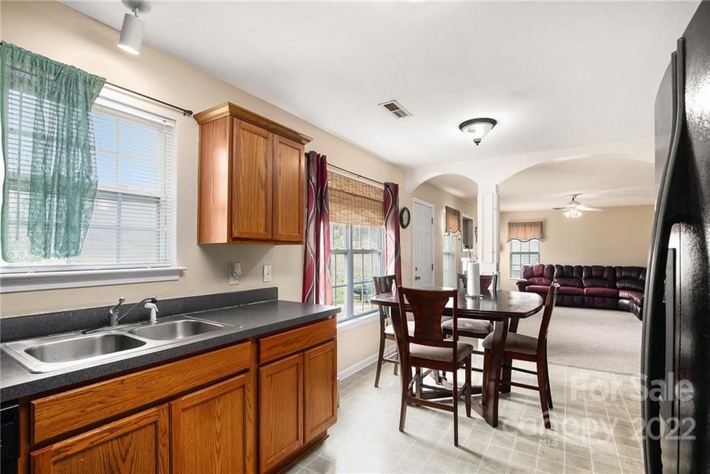 1222 Ben Livingston Road Charlotte, NC 28214 - Photo 16 of 32 a large kitchen with lots of counter space and windows