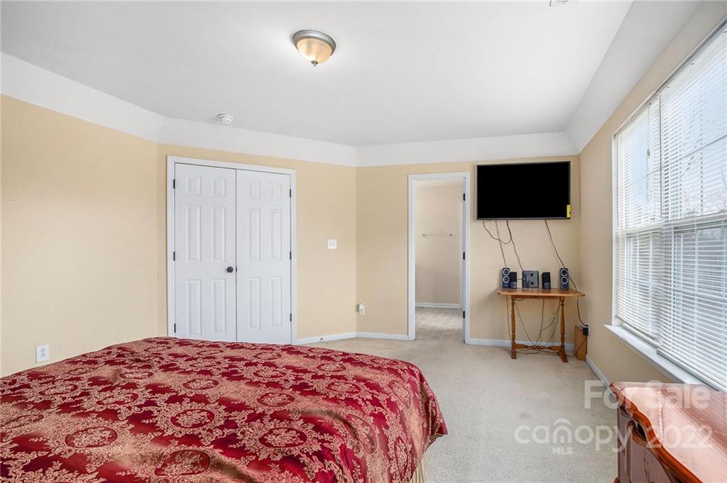 1222 Ben Livingston Road Charlotte, NC 28214 - Photo 19 of 32 a bedroom with a bed and a flat screen tv