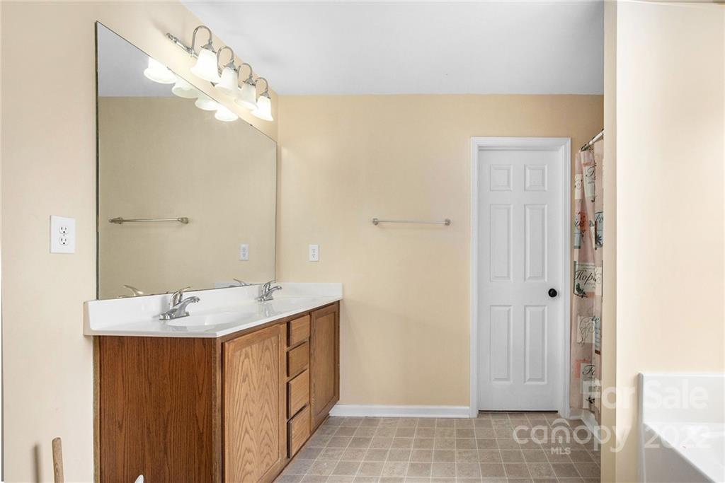 1222 Ben Livingston Road Charlotte, NC 28214 - Photo 20 of 32 a bathroom with a sink and a mirror