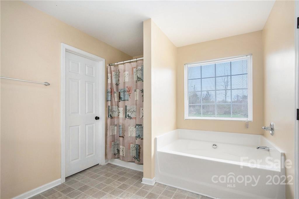 1222 Ben Livingston Road Charlotte, NC 28214 - Photo 21 of 32 a bathroom with a bathtub and a shower
