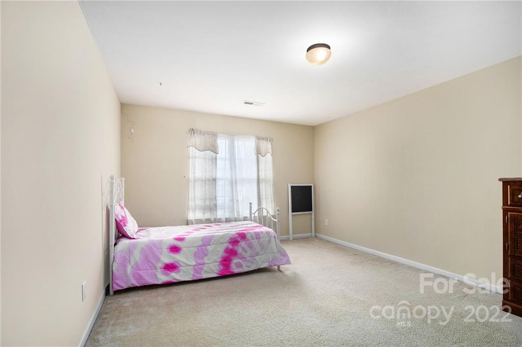 1222 Ben Livingston Road Charlotte, NC 28214 - Photo 23 of 32 a bedroom with a bed and a window