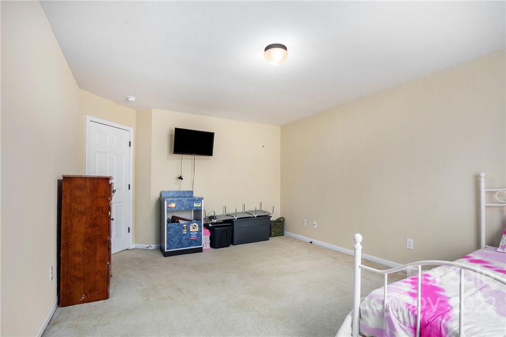1222 Ben Livingston Road Charlotte, NC 28214 - Photo 24 of 32 a living room with furniture and a flat screen tv
