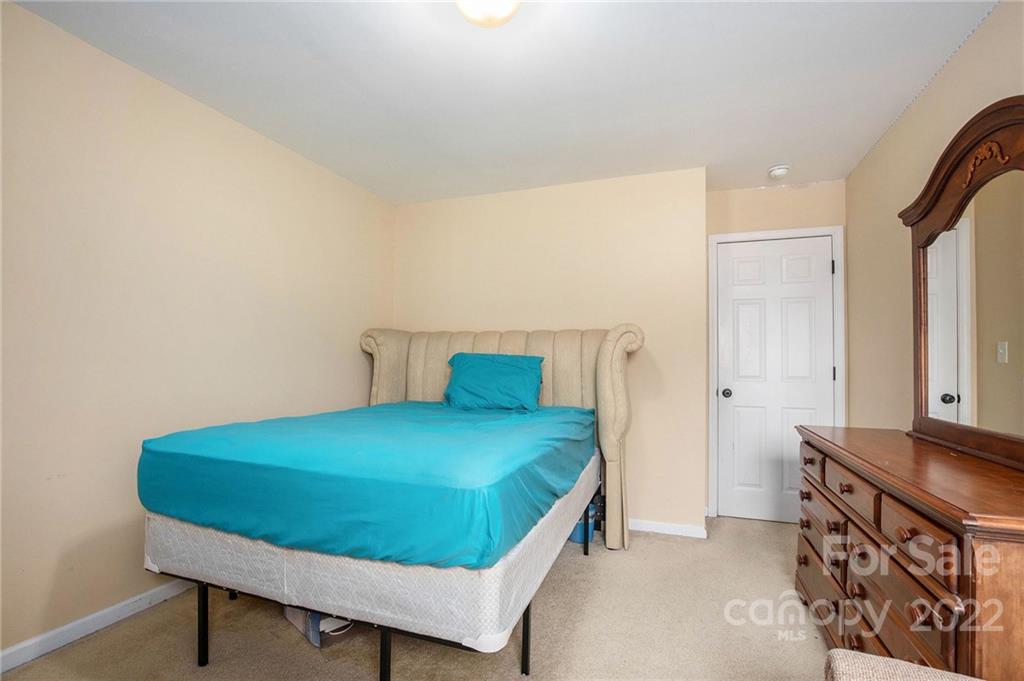 1222 Ben Livingston Road Charlotte, NC 28214 - Photo 26 of 32 a bedroom with a bed and a dresser