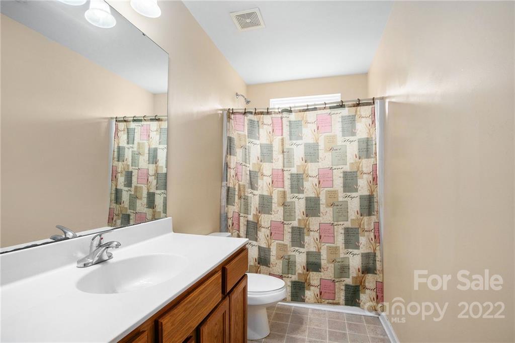 1222 Ben Livingston Road Charlotte, NC 28214 - Photo 27 of 32 a bathroom with a sink a toilet and shower