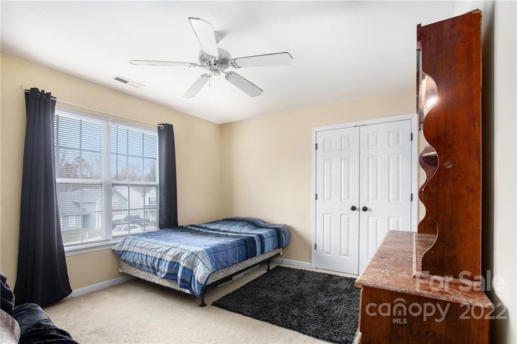 1222 Ben Livingston Road Charlotte, NC 28214 - Photo 28 of 32 a bedroom with a bed and a window