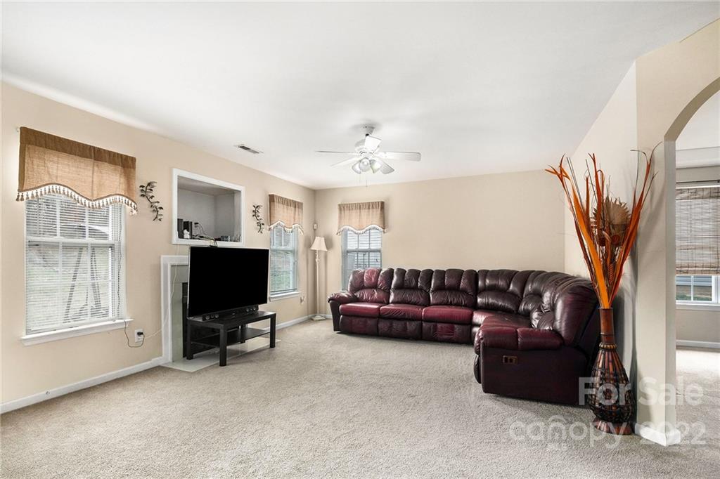 1222 Ben Livingston Road Charlotte, NC 28214 - Photo 9 of 32 a living room with furniture and a flat screen tv