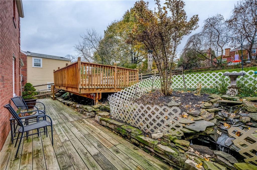 24 Leon Road Pittsburgh, PA 15220 - Photo 20 of 24 Custom Built Rock Waterfall is surround by a garden space that becomes full bloom in the summer. Waterfall includes a pump