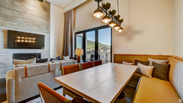 2417 West High Road, Unit 2515 Park City, UT 84098 - Photo 9 of 67 Dining room featuring a high ceiling and a large fireplace