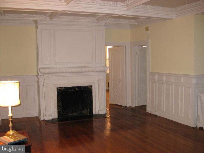10 Club Road Baltimore, MD 21210 - Photo 4 of 8 a view of a livingroom with wooden floor and a fireplace