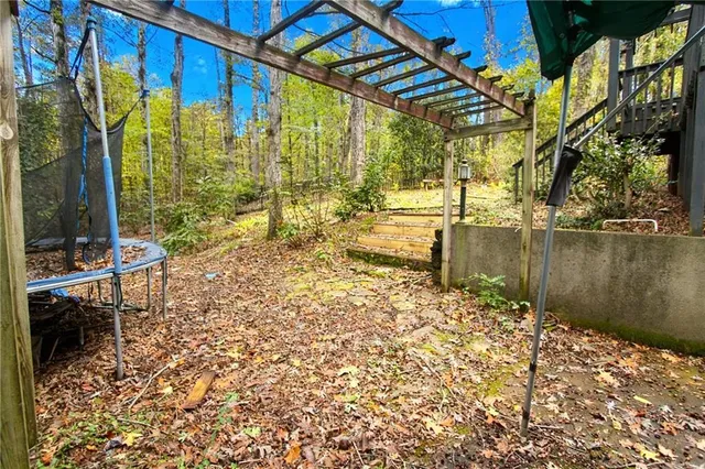 a backyard of a house with table and chairs