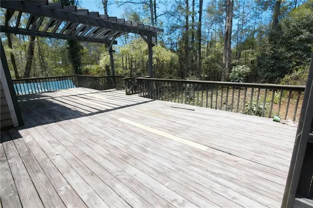 a view of a roof deck with wooden floor and fence