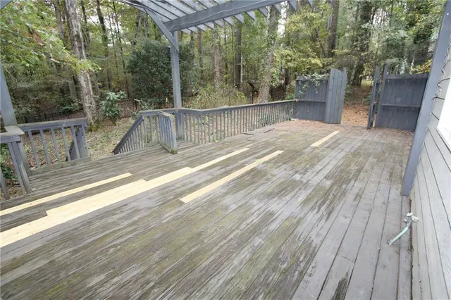 a view of balcony with wooden floor and fence