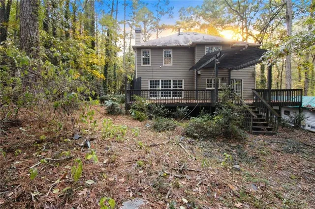 a front view of a house with yard and green space