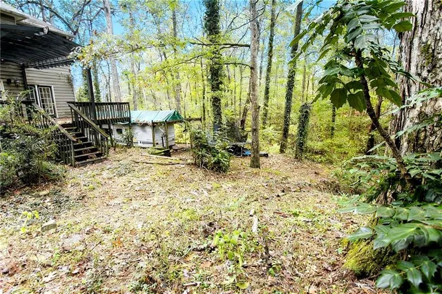 a backyard of a house with table and chairs