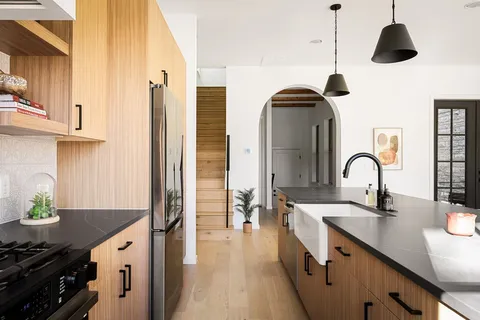 a kitchen with stainless steel appliances granite countertop a sink and a stove