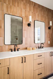 a bathroom with a double vanity sink and mirror