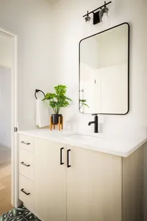 a bathroom with a sink and mirror