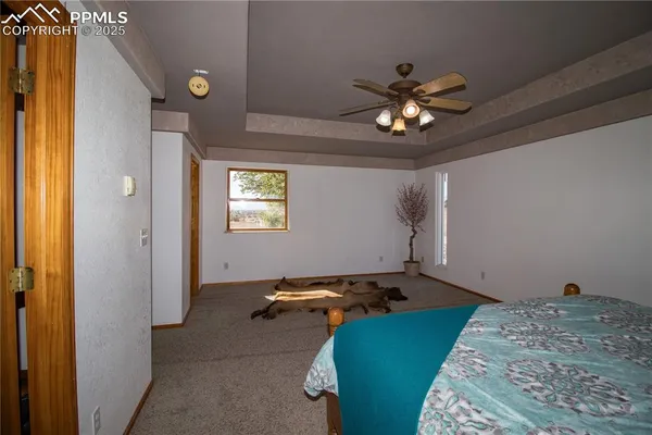 a bedroom with bed and a chandelier