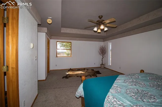 a bedroom with bed and a chandelier
