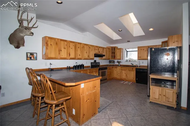 a kitchen with stainless steel appliances granite countertop a sink counter space cabinets and a counter top space