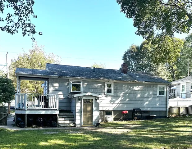 a front view of a house with a garden and swimming pool