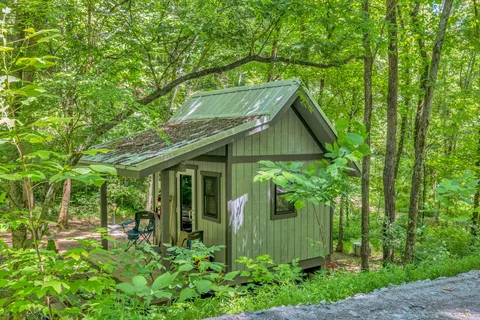 front view of house with a tree in front of it