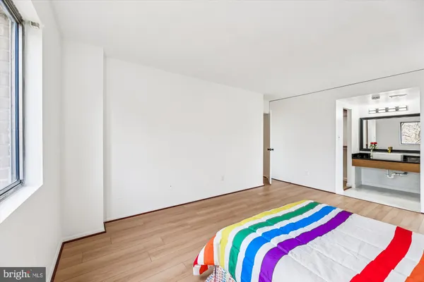a bedroom with a bed and a view of kitchen