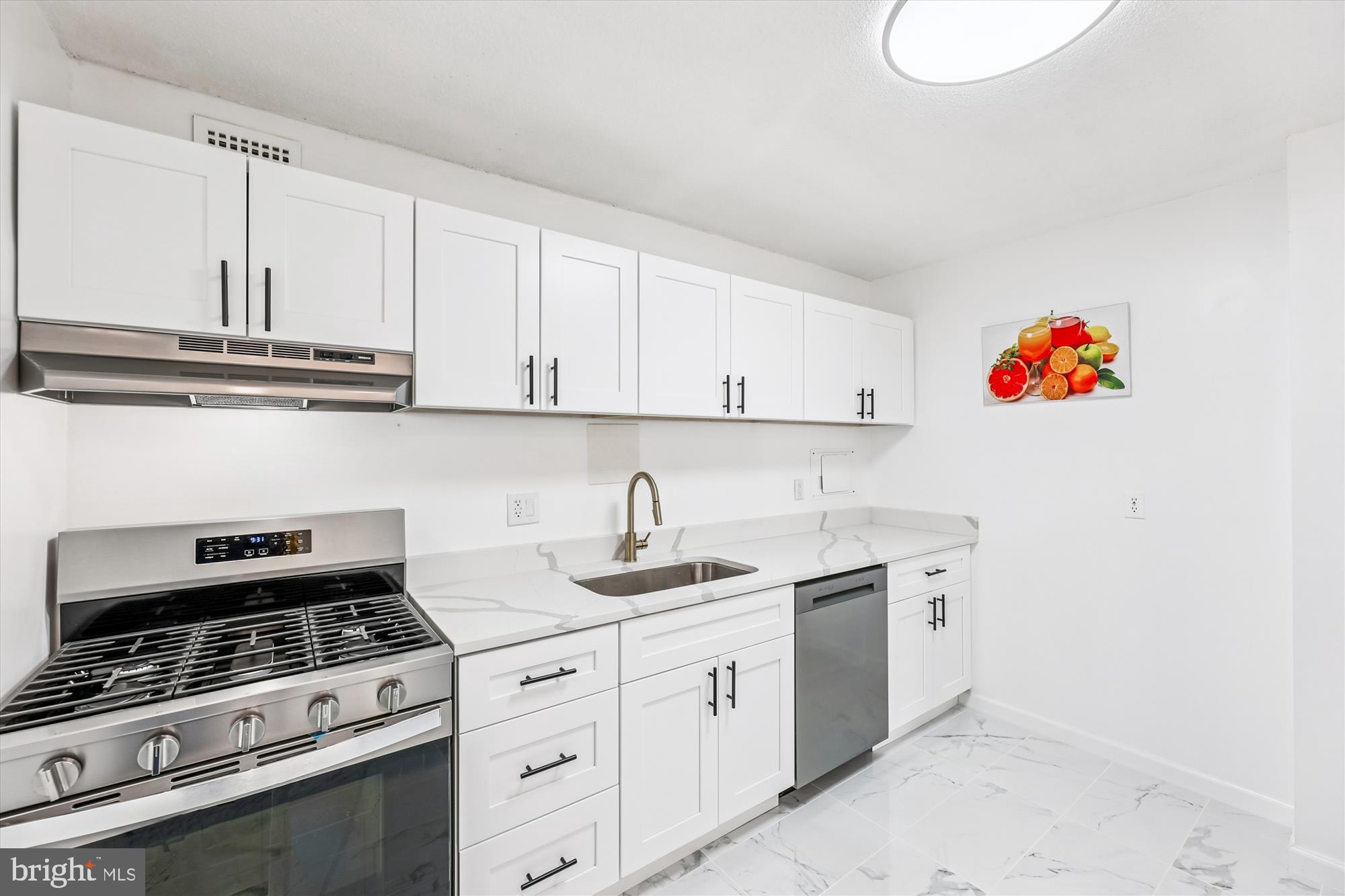 1836 Metzerott Road, Unit T3 Hyattsville, MD 20783 - Photo 4 of 28 a kitchen with stainless steel appliances granite countertop a stove a sink and a white cabinets
