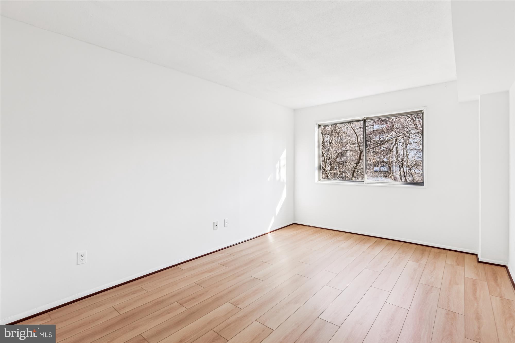1836 Metzerott Road, Unit T3 Hyattsville, MD 20783 - Photo 10 of 28 an empty room with wooden floor and window