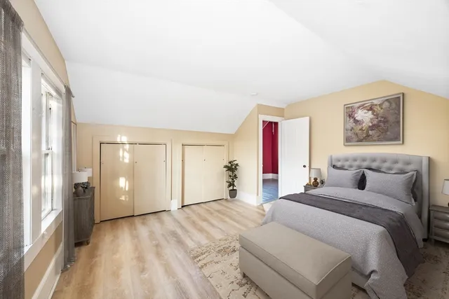 a bedroom with a bed and a large window